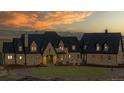 Elegant estate home at dusk with mountain views at 7755 Moore Rd, Littleton, CO 80125