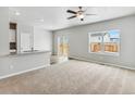 Spacious Gathering room with carpeting, a ceiling fan, and sliding glass doors at 819 Sunflower Dr, Brighton, CO 80601