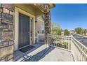 Front entry with dark door and stone accents at 6655 S Shawnee St, Aurora, CO 80016