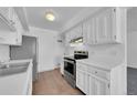 Modern kitchen featuring stainless steel appliances and white cabinets at 9947 Croke Dr, Denver, CO 80260