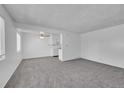 Bright and airy living room with gray carpeting and open floor plan at 9947 Croke Dr, Denver, CO 80260