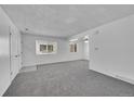 Spacious living room with gray carpet and lots of natural light at 9947 Croke Dr, Denver, CO 80260