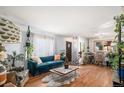 Spacious living area with hardwood floors and plenty of natural light at 7887 Quivas Way, Denver, CO 80221