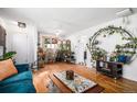 Bright living room featuring hardwood floors and eclectic decor at 7887 Quivas Way, Denver, CO 80221