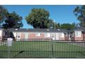 Brick building with a fenced yard at 1539 N Xenia St, Denver, CO 80220