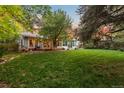 Large backyard with grassy area, patio, and screened-in porch at 9641 Sierra Dr, Arvada, CO 80005