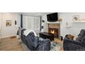 Living room with fireplace, comfortable seating, and hardwood floors at 13 Nome Way # A, Aurora, CO 80012
