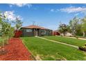 Ranch home exterior with a large front yard and mature trees at 9400 Lilly Ct, Thornton, CO 80229