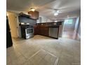 Modern kitchen featuring stainless steel appliances and tiled floors at 1522 Tamarac St, Denver, CO 80220