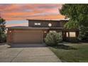 Evening view of two-story home with attached two-car garage at 1058 W Choke Cherry Dr, Louisville, CO 80027