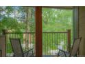 Private balcony with chairs overlooks a tree-filled landscape at 465 Four Oclock Rd # 323, Breckenridge, CO 80424
