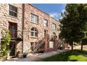 Stone-built townhouses with stairs and a landscaped lawn at 1415 E 16Th Ave # 1/2, Denver, CO 80218