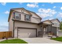 Two-story house with gray siding, attached garage, and landscaping at 7302 Arkansas Street, Frederick, CO 80530
