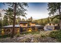 Modern home nestled in the mountains with a large deck and two-car garage at 32651 Buffalo Creek Rd, Evergreen, CO 80439