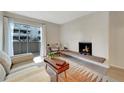 Living room featuring a fireplace and access to a balcony at 4110 Hale Pkwy # 3J, Denver, CO 80220