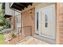 Townhouse entry with brick facade and storm door at 3061 W 92Nd Ave # 5C, Westminster, CO 80031