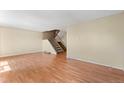 Living room with laminate wood floors and staircase at 3061 W 92Nd Ave # 5C, Westminster, CO 80031