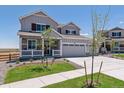 Two-story house with gray siding and two-car garage at 3282 N Highlands Creek Pkwy, Aurora, CO 80019