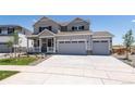 Two-story house with gray siding and two-car garage at 3282 N Highlands Creek Pkwy, Aurora, CO 80019