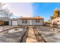 Charming gray house with a landscaped yard and a bird bath at 7651 Kearney Dr, Commerce City, CO 80022