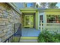 Front porch with stone exterior and a glass door entrance at 9169 Sugarstone Cir, Highlands Ranch, CO 80130