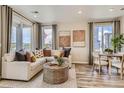 Bright and airy living room with large windows and comfortable seating at 458 Millwall Cir, Castle Pines, CO 80108