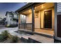 Inviting front porch with dark door and gray steps at 9307 Inca Dove Cir, Littleton, CO 80125