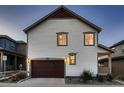 Two-story house with dark brown garage door and light-colored siding at 9307 Inca Dove Cir, Littleton, CO 80125