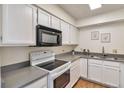 Bright kitchen with white cabinets and gray countertops at 1850 Folsom St # 411, Boulder, CO 80302