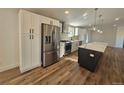 Modern kitchen with stainless steel appliances, white cabinets, and quartz countertops at 69345 County Road 34, Byers, CO 80103