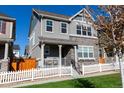 Beautiful two story home with gray siding and white picket fence at 13778 Umatilla Ln, Broomfield, CO 80023