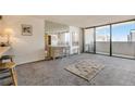 Living room features a view, built-in shelving and hardwood floors at 1020 15Th St # 25F, Denver, CO 80202