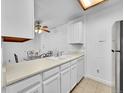 White kitchen cabinets, a breakfast bar, and a view into the dining area at 14751 E Tennessee Dr # 225, Aurora, CO 80012