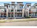 Modern townhouses with private balconies and landscaped yards at 10065 Town Ridge Ln, Lone Tree, CO 80124