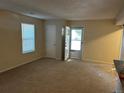 Spacious living room with carpeting, neutral walls, and a view to the kitchen at 3 Amesbury St, Broomfield, CO 80020