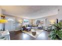 Living room with hardwood floors and a gray sectional sofa at 28 W Broadmoor Dr, Littleton, CO 80120