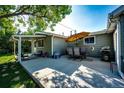 Covered patio with seating area and outdoor dining set at 1716 Main St, Strasburg, CO 80136