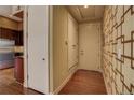 Entryway with wood floors and a geometric patterned wall at 1488 Madison St # 211, Denver, CO 80206