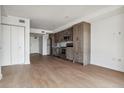 Open living room with hardwood floors and modern kitchen at 3575 Chestnut Pl # 601, Denver, CO 80216