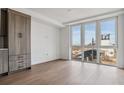 Bright living room with large windows and hardwood floors at 3575 Chestnut Pl # 601, Denver, CO 80216