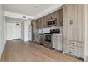 Modern kitchen with stainless steel appliances and wood cabinets at 3575 Chestnut Pl # 601, Denver, CO 80216