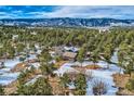 House with mountain views and snow-covered landscape at 1298 Silverheels Dr, Larkspur, CO 80118