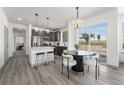 Modern kitchen with dark cabinetry, island, and stainless steel appliances at 18633 Stroh Rd # 1-106, Parker, CO 80134