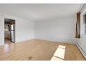 Bright living room with hardwood floors and view of kitchen at 18227 W 3Rd Pl # 4, Golden, CO 80401