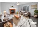 Virtually staged living room featuring a fireplace and comfortable seating at 12334 Nate Cir, Parker, CO 80134