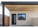 Modern front entrance with a black door and a wood-paneled ceiling at 1374 Perry St, Denver, CO 80204