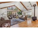 Spacious living room with hardwood floors, high ceilings, and a cozy fireplace at 3081 W 151St Ct, Broomfield, CO 80023