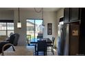 Bright dining area with table and chairs, adjacent to the kitchen at 22345 E Bailey Pl, Aurora, CO 80016