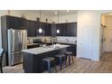 Modern kitchen with dark cabinetry, granite countertops, and an island at 22345 E Bailey Pl, Aurora, CO 80016