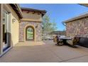 Outdoor patio with seating area, stone archway, and scenic views at 4822 Bandera Pl, Parker, CO 80134